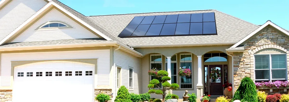 A charming brick home in Spring Lake, UT, with a well-installed array of dark solar panels covering the roof, surrounded by lush green trees and neighboring houses, showcasing a blend of modern renewable energy and natural beauty.
