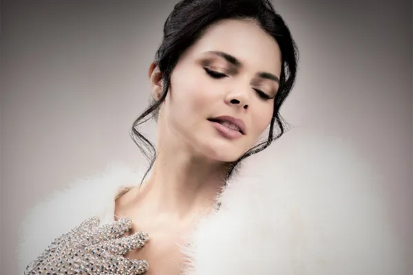 woman with sparkle adorned gloves