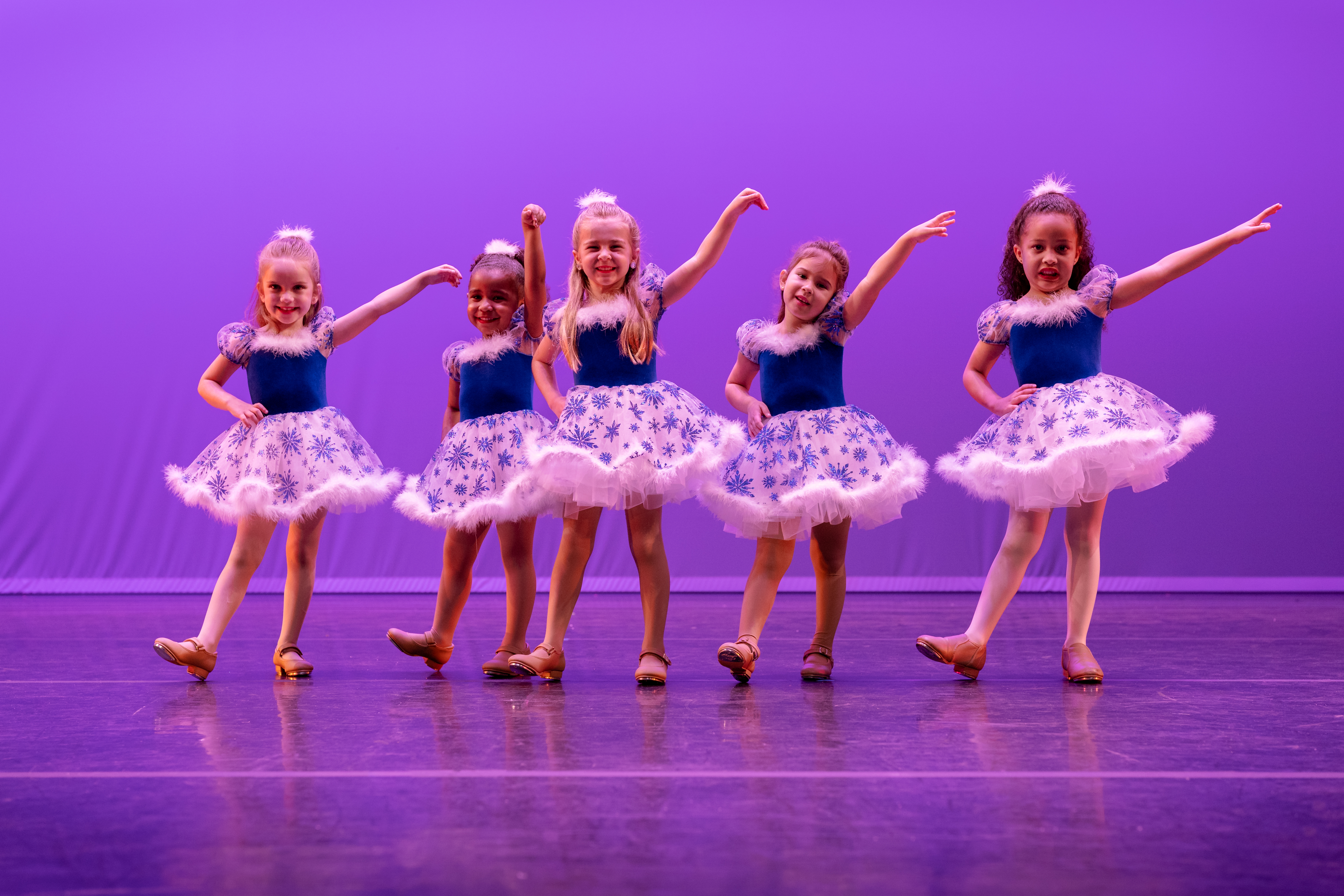 Young dancers performing a tap dance on stage at a show