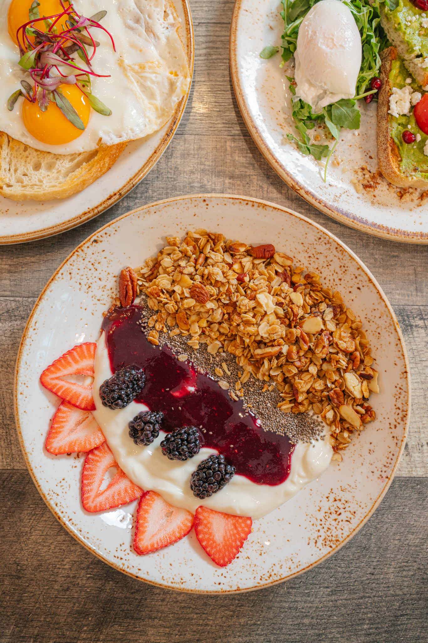 All-day brunch plate with granola, berries, and yogurt at The Aussie Grind Frisco