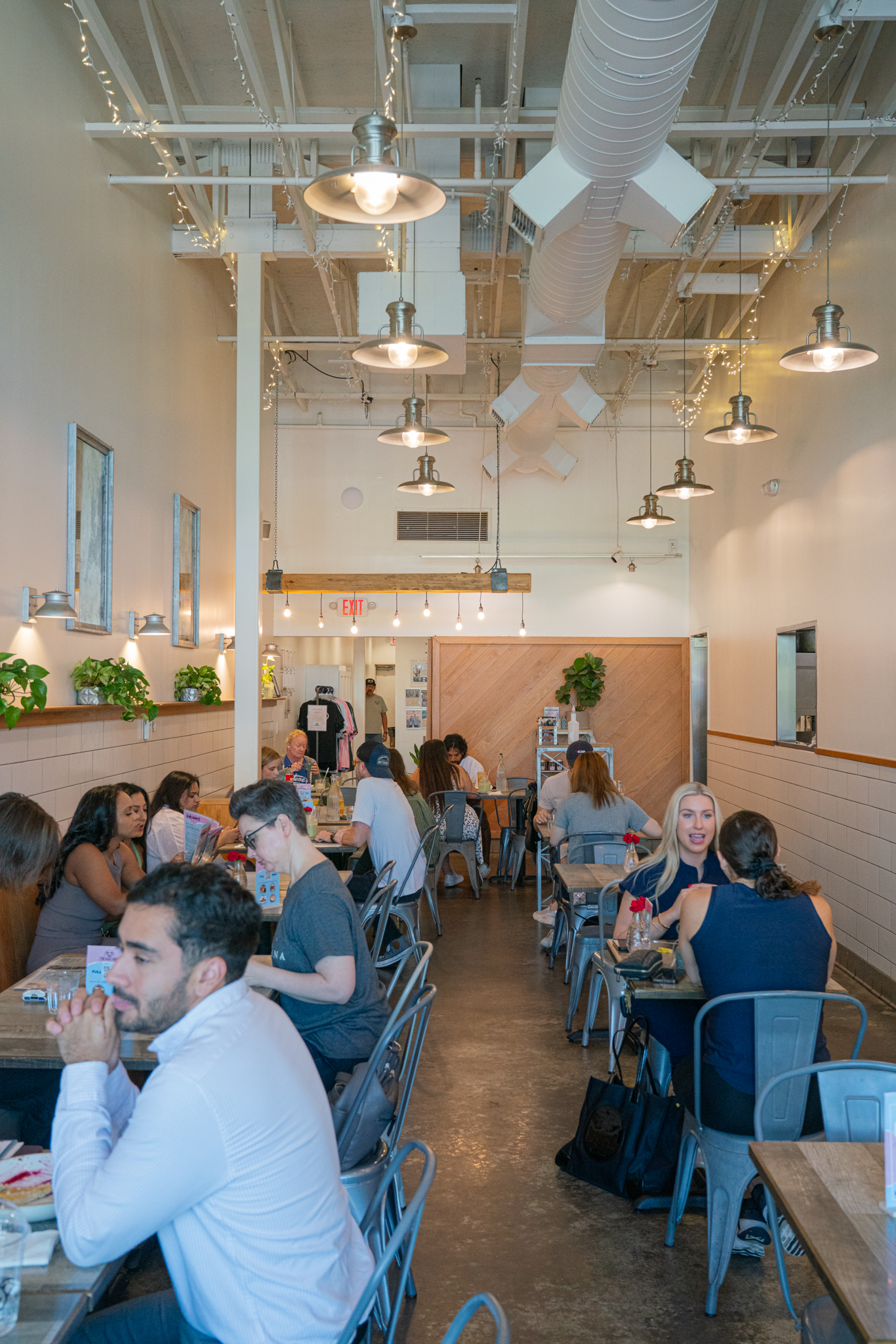 Full-service Australian café interior at The Aussie Grind Frisco with guests dining