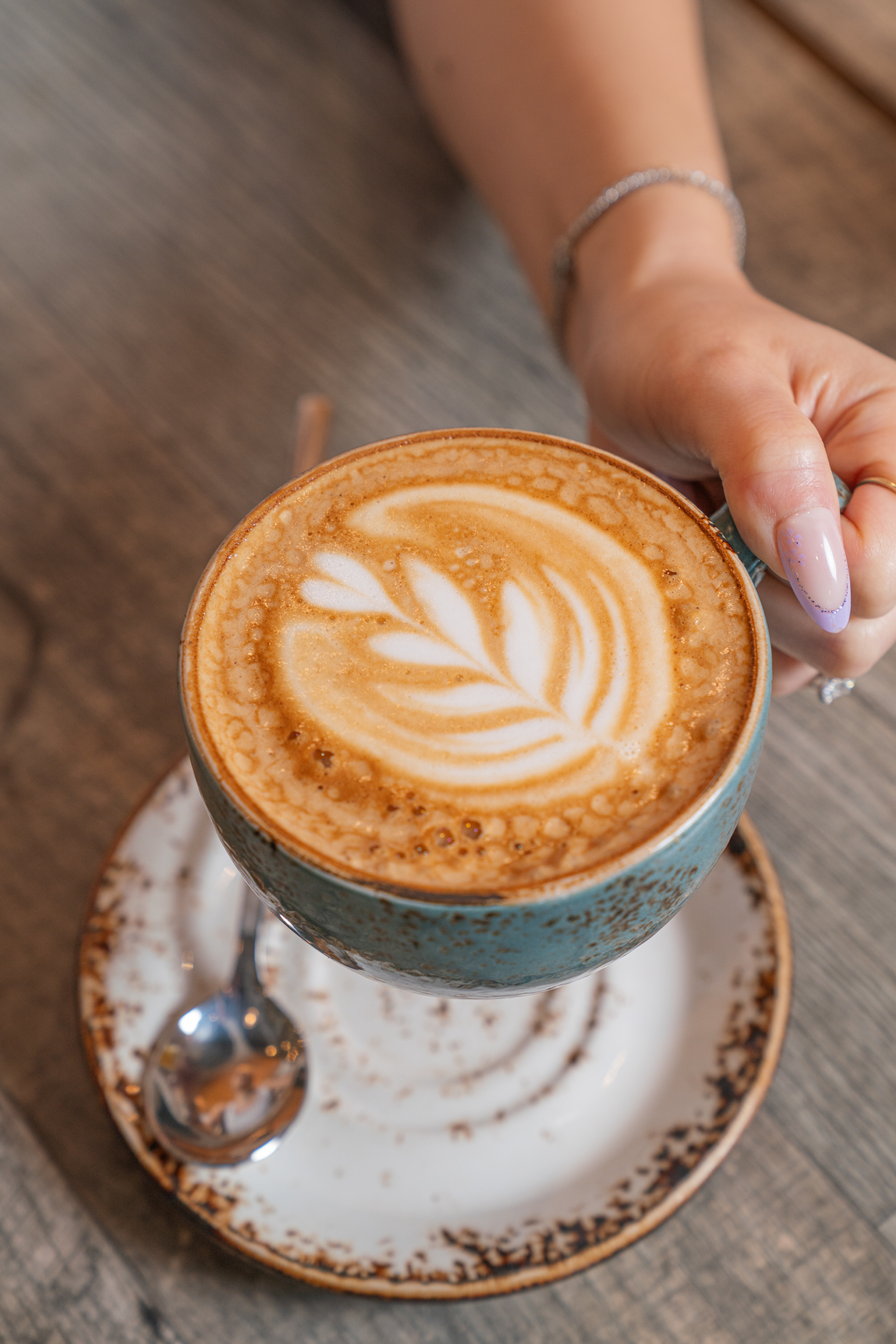 Latte art in a ceramic mug at The Aussie Grind specialty coffee bar in Frisco