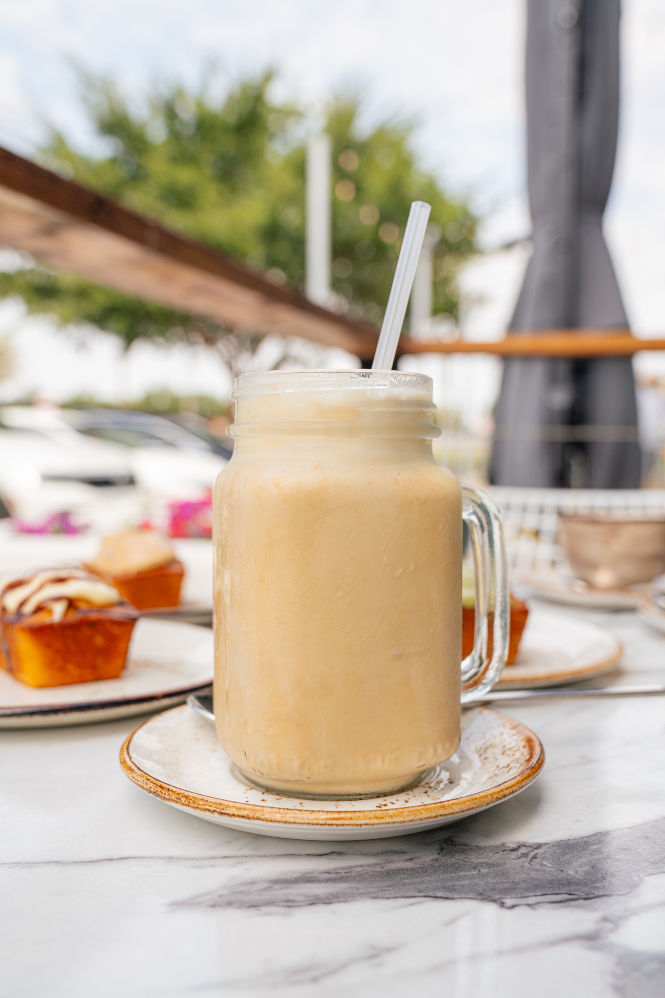 Fresh pineapple iced drink served outdoors at The Aussie Grind Provisions café
