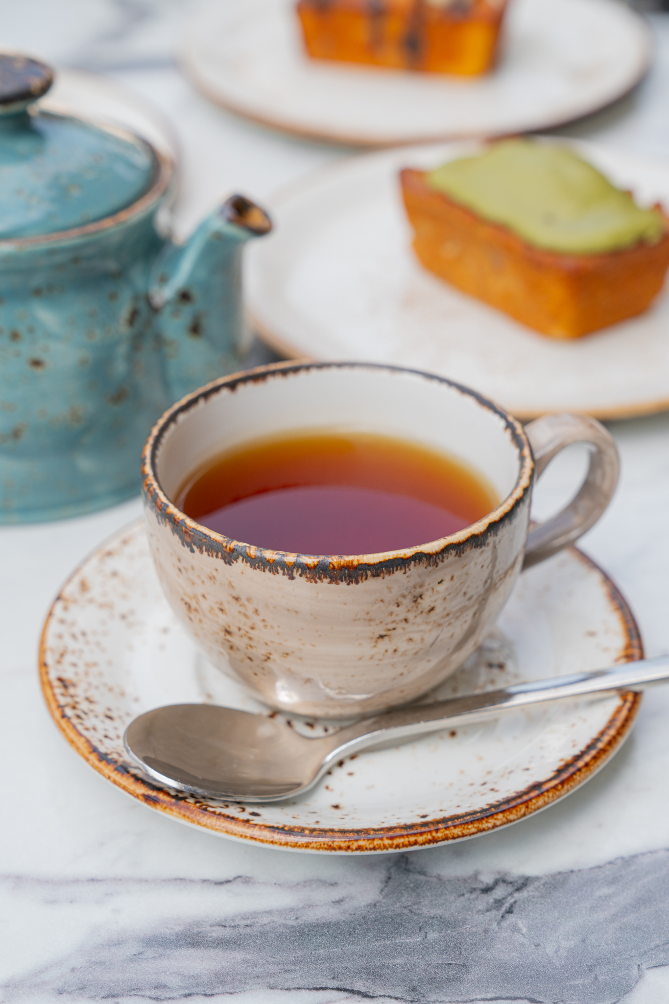 White ceramic cup of freshly brewed loose leaf tea at Australian café in Farmers Branch, Texas