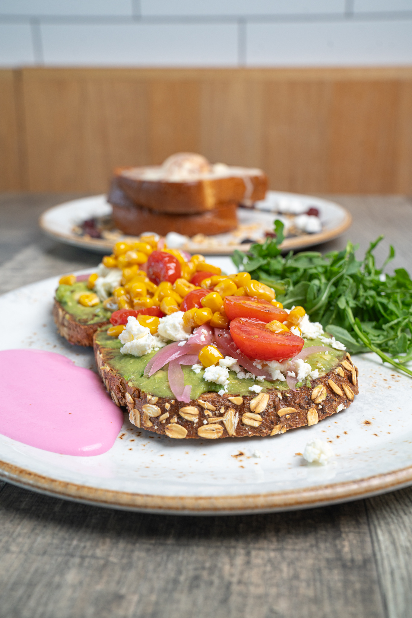 Avocado toast topped with roasted corn, cherry tomatoes, and feta at The Aussie Grind Frisco
