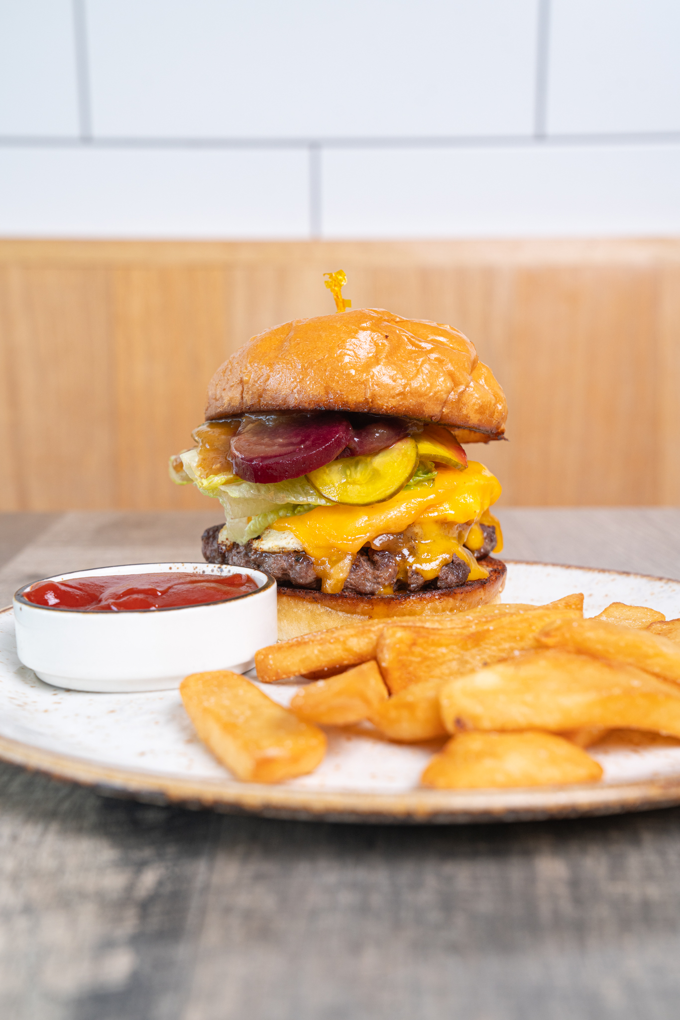 Australian-style burger with beetroot, cheddar, pickles, and fries at The Aussie Grind Frisco