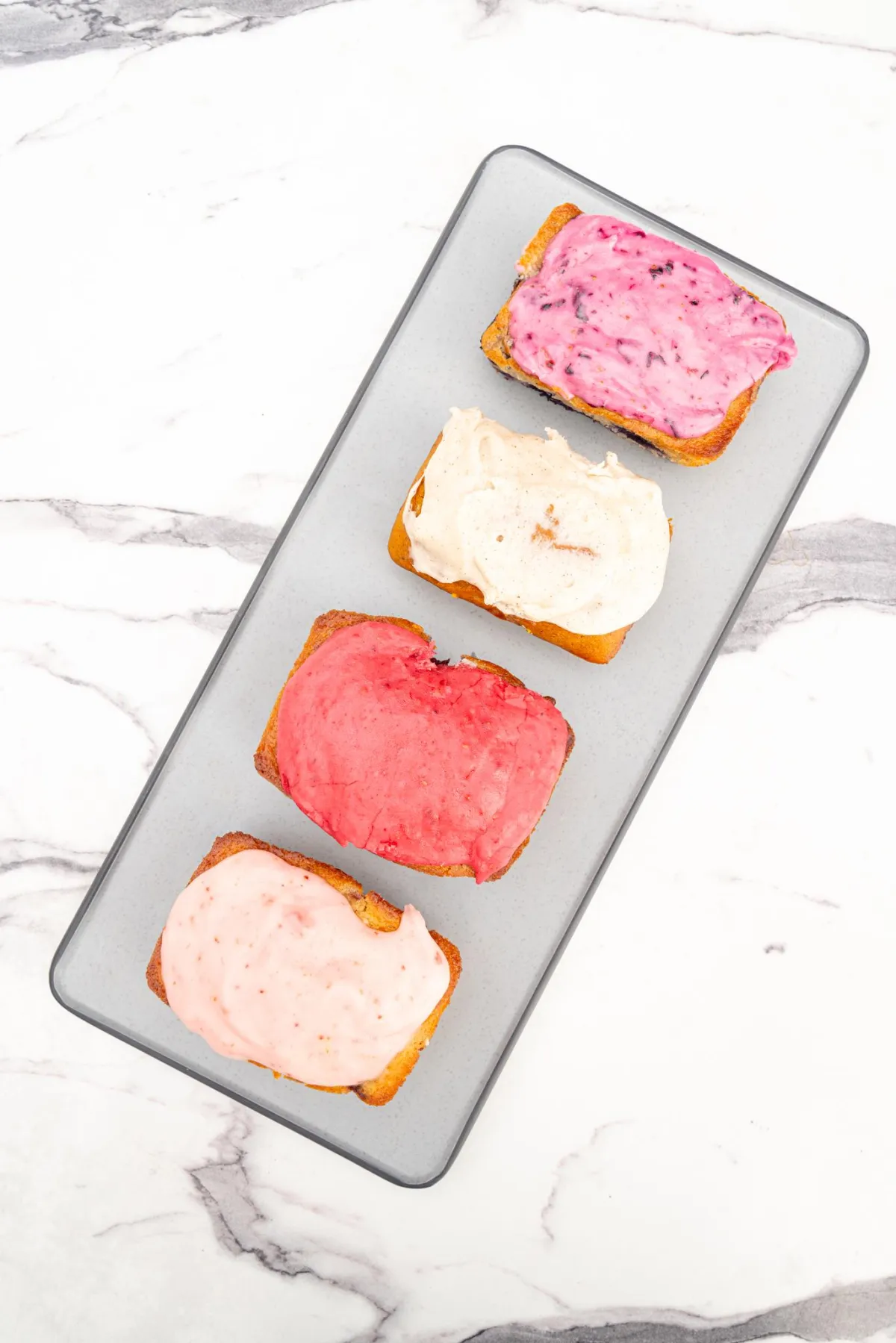 Assorted Australian-style toast slices with colorful icing at Provisions bakery