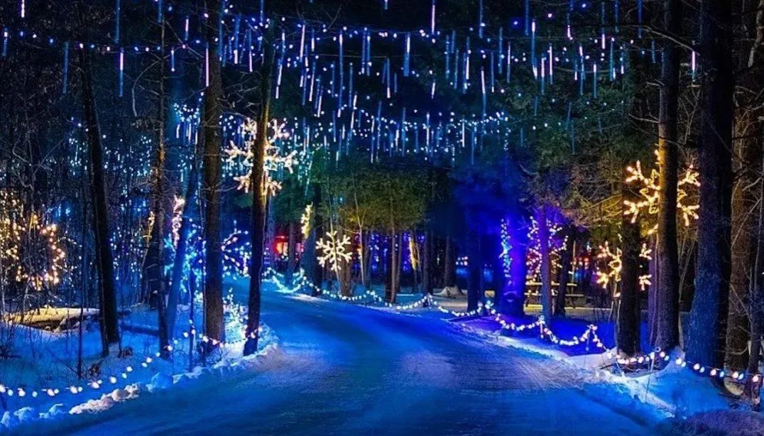 Festive holiday scene with a brightly lit Christmas tree, people enjoying winter activities, and cozy decorations, capturing the holiday spirit in a small-town setting.