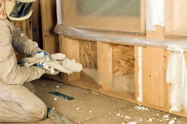 Wall cavity filled with open-cell spray foam for energy efficiency