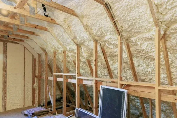 Installing open-cell spray foam for wall insulation and soundproofing