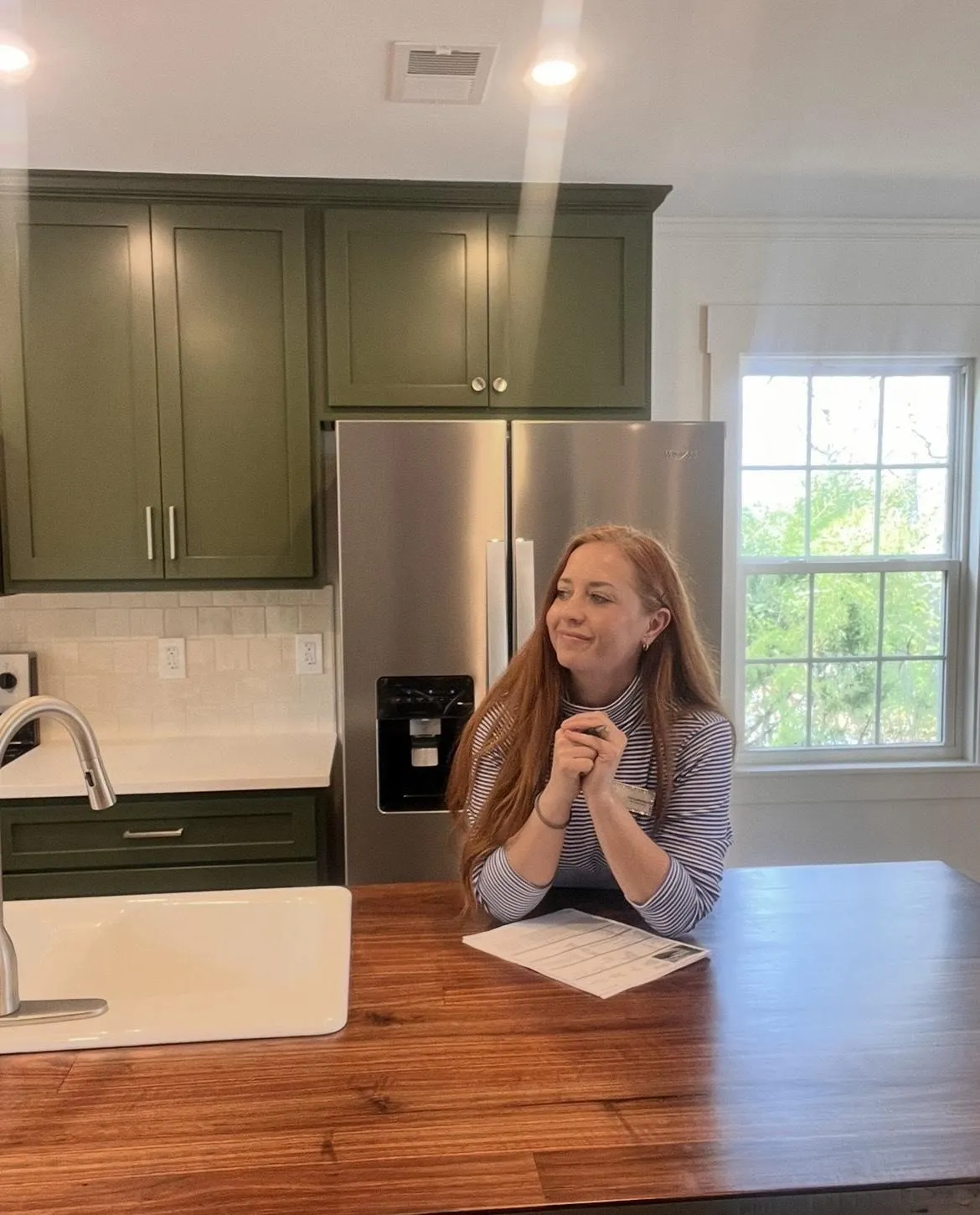 Girl at kitchen island looking happily and smiling
