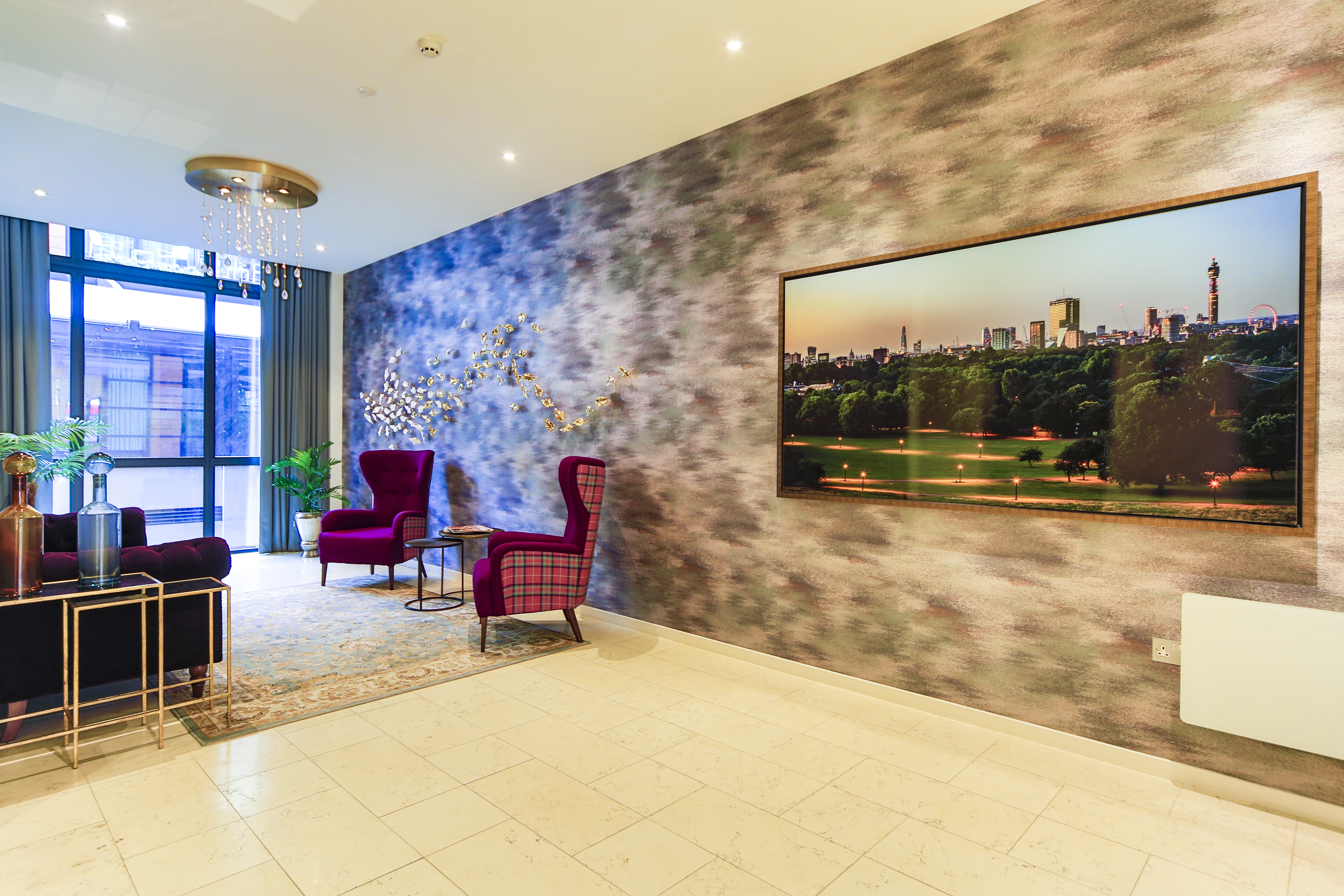 Boutique hotel lounge with feature wall, modern seating and artwork in London