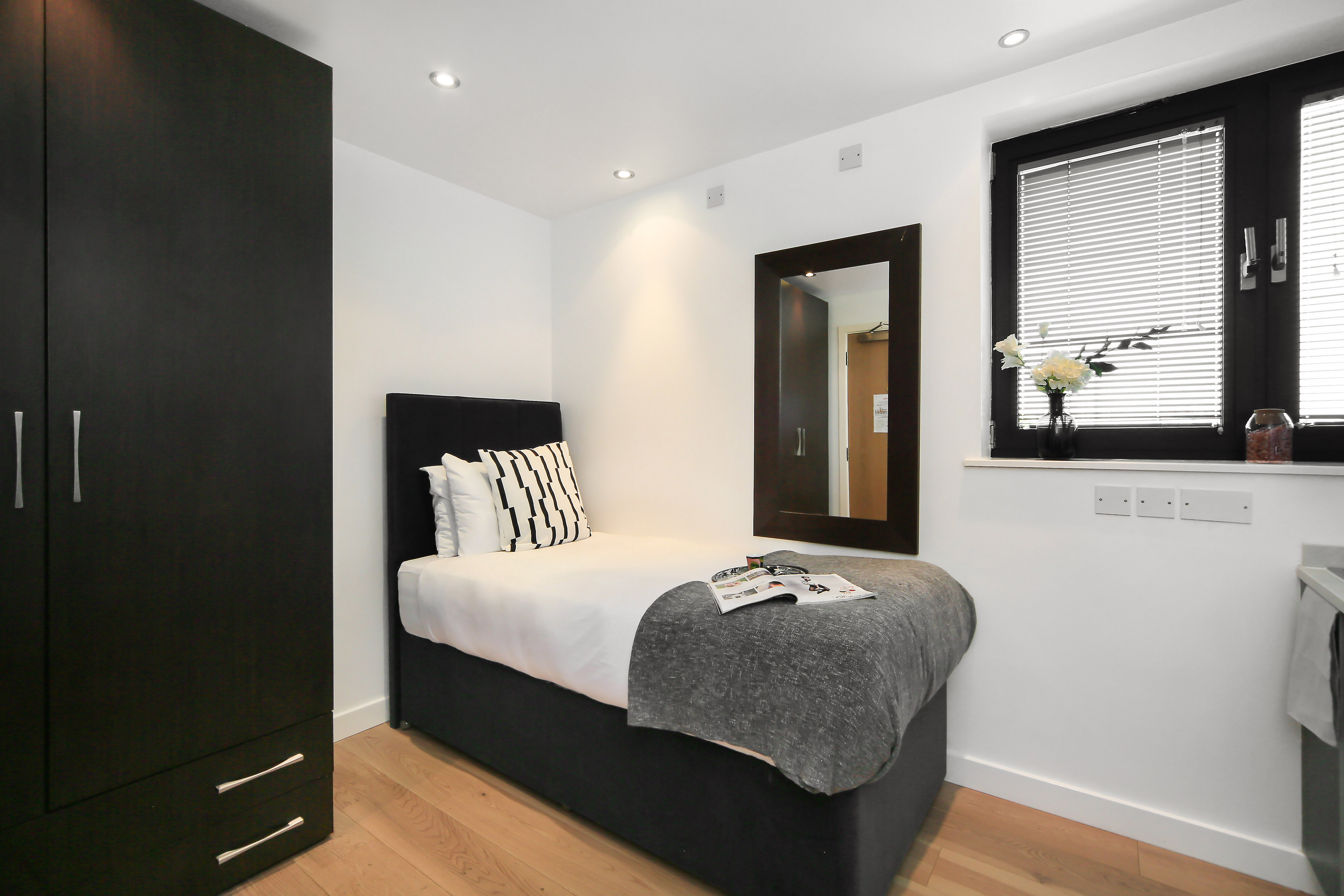 Modern single hotel room with minimalist interior design