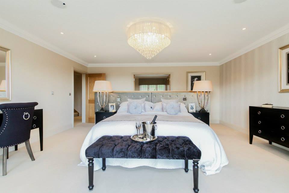 Luxury hotel bedroom with chandelier and elegant furnishings