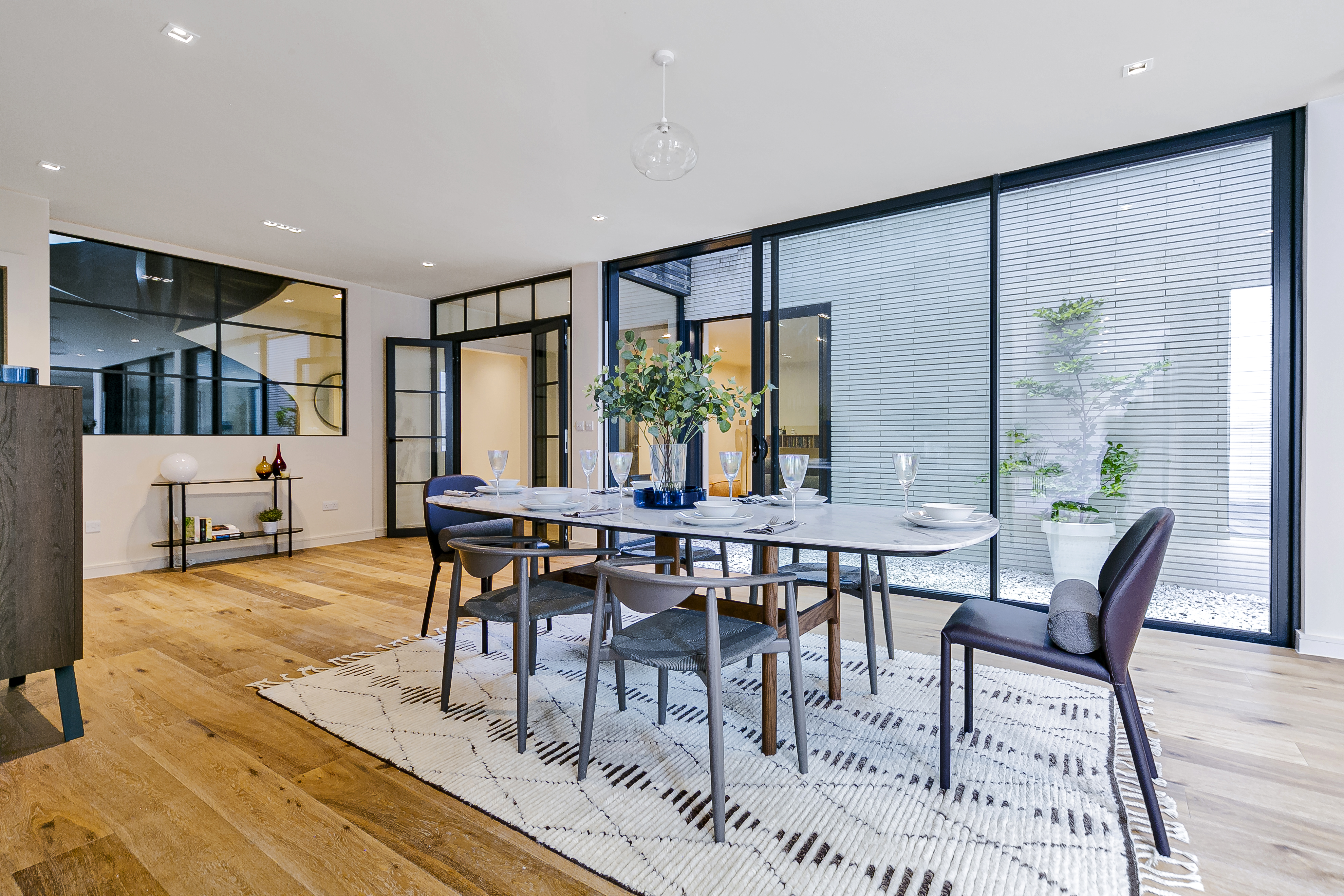 Dining area photographed for a London residential property listing with large windows