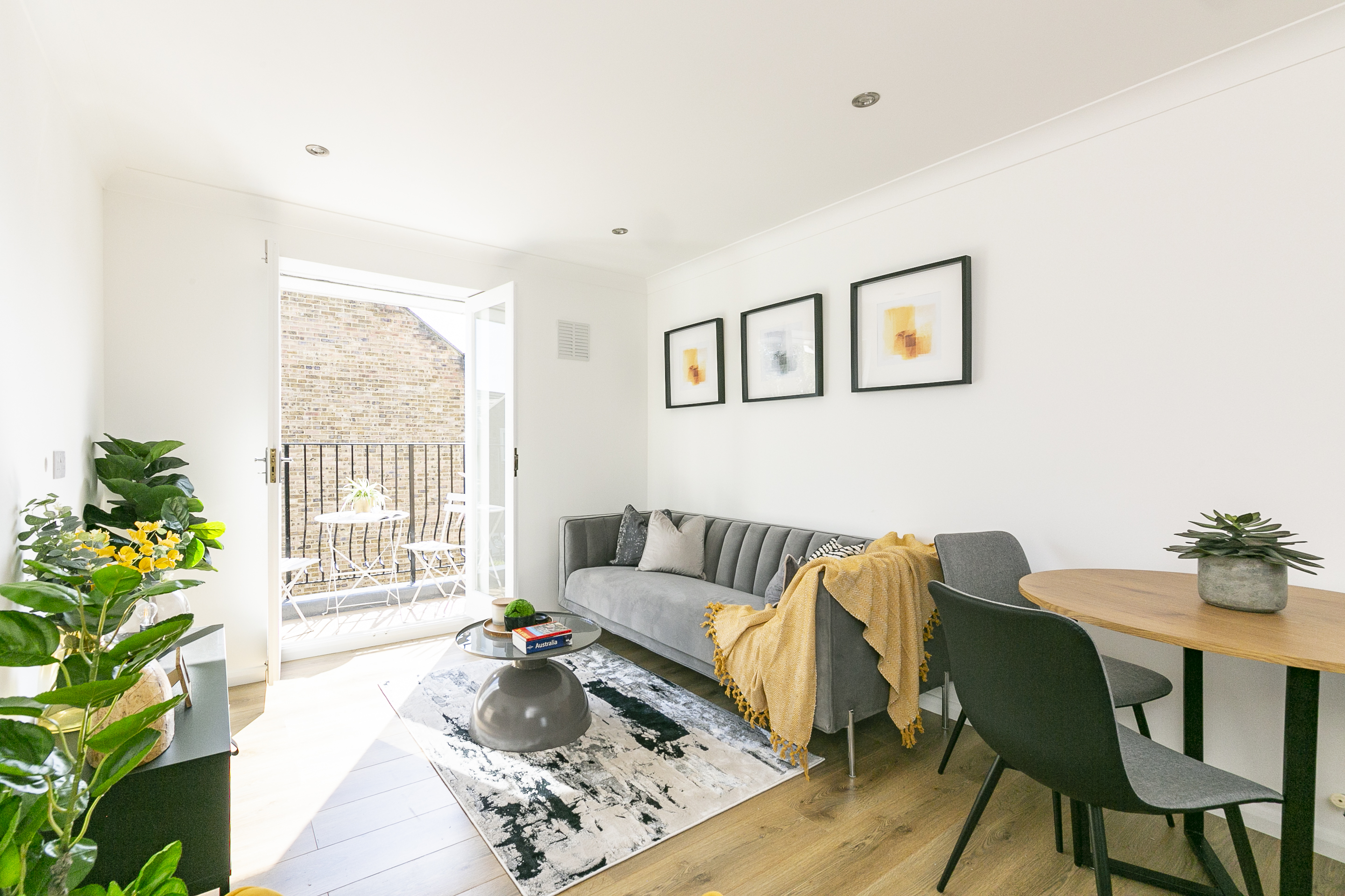Living and dining area photographed for a London residential property listing with balcony access