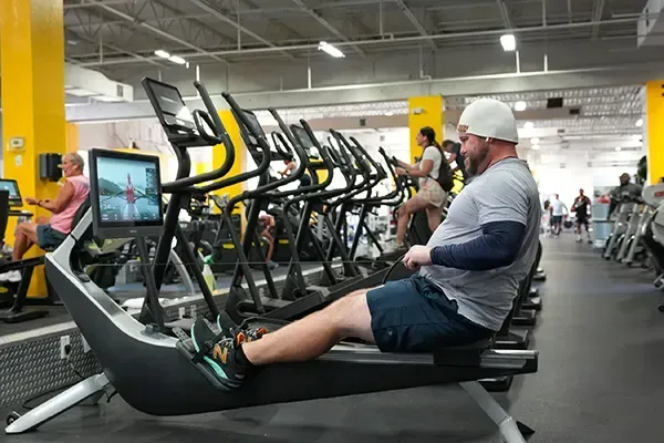A member rowing at The New Boca Raton Fitness Center