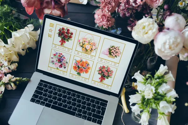 laptop open with different types of floral arrangements