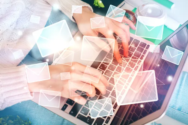 lady typing on a keyboard and floating transparent envelopes