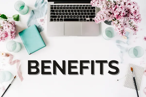 laptop with notebook and flowers and the word benefits on the screen