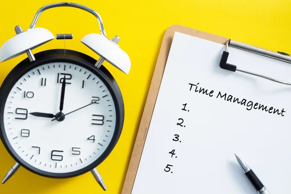 a clock and a clipboard with time management written on it