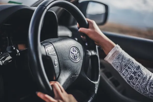 Hands driving using Toyota steering wheel 