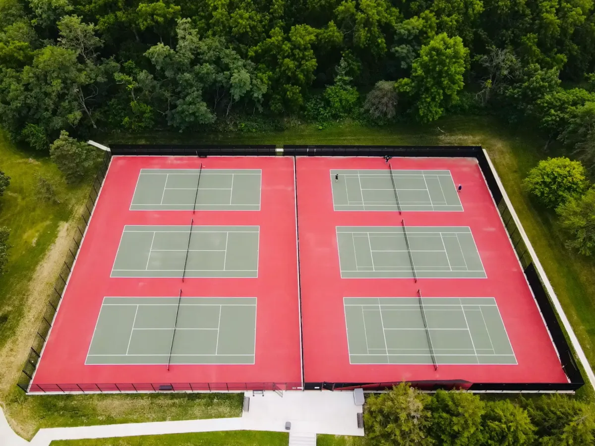drone shot of a tennis court for topic on how many pickleball courts fit in a tennis court