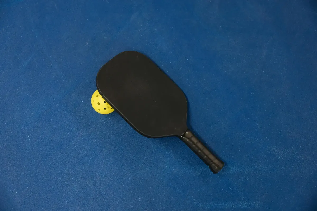 picture of a pickleball racket and ball