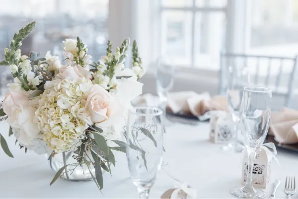 Wedding reception table with flowers and tableware