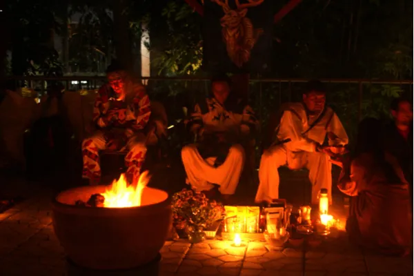 Participants gathered around Marakame Juan during an all-night indigenous ceremony, symbolizing spiritual connection and self-discovery.