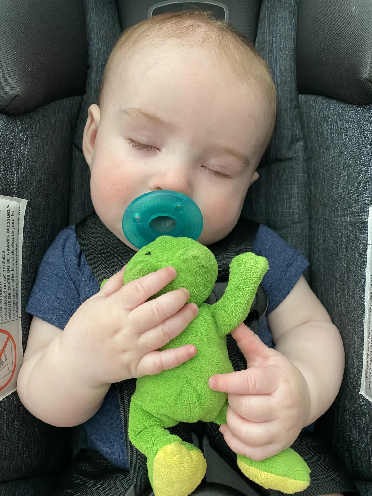 Sleeping baby with a pacifier in his mouth