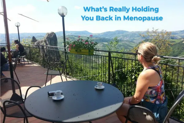 A woman in colourful hiking gear sits on a sunny Italian terrace with an espresso, overlooking rolling green hills - a quiet moment of reflection and rest