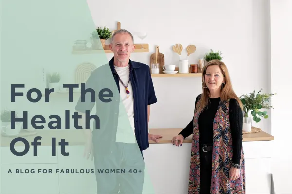 Menopause coaches James & Juli standing in a bright kitchen with the text 'For The Health Of It - A blog for fabulous women 40+
