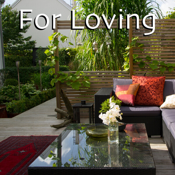 Cosy outdoor lounge garden with modern furniture and lush planting