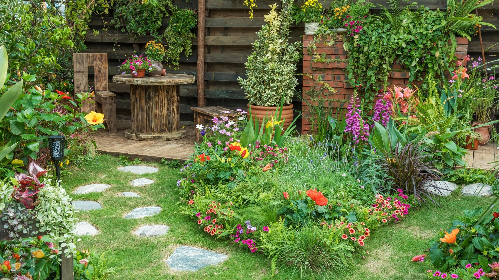 Wildlife-friendly garden in Wallington with stepping stones, cottage-style planting and natural landscaping