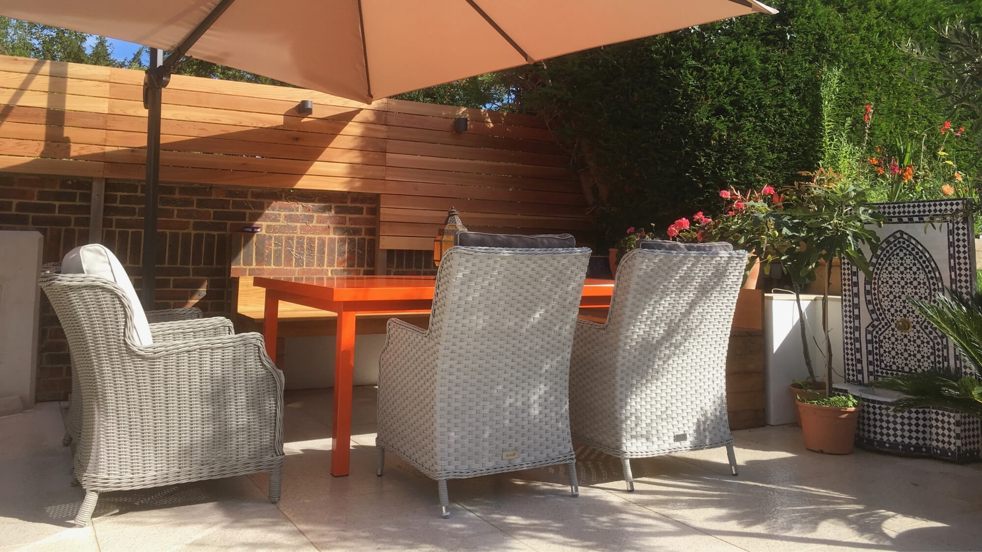 After: finished patio dining area with planting in a Carshalton garden designed and built by EarthCare Gardens