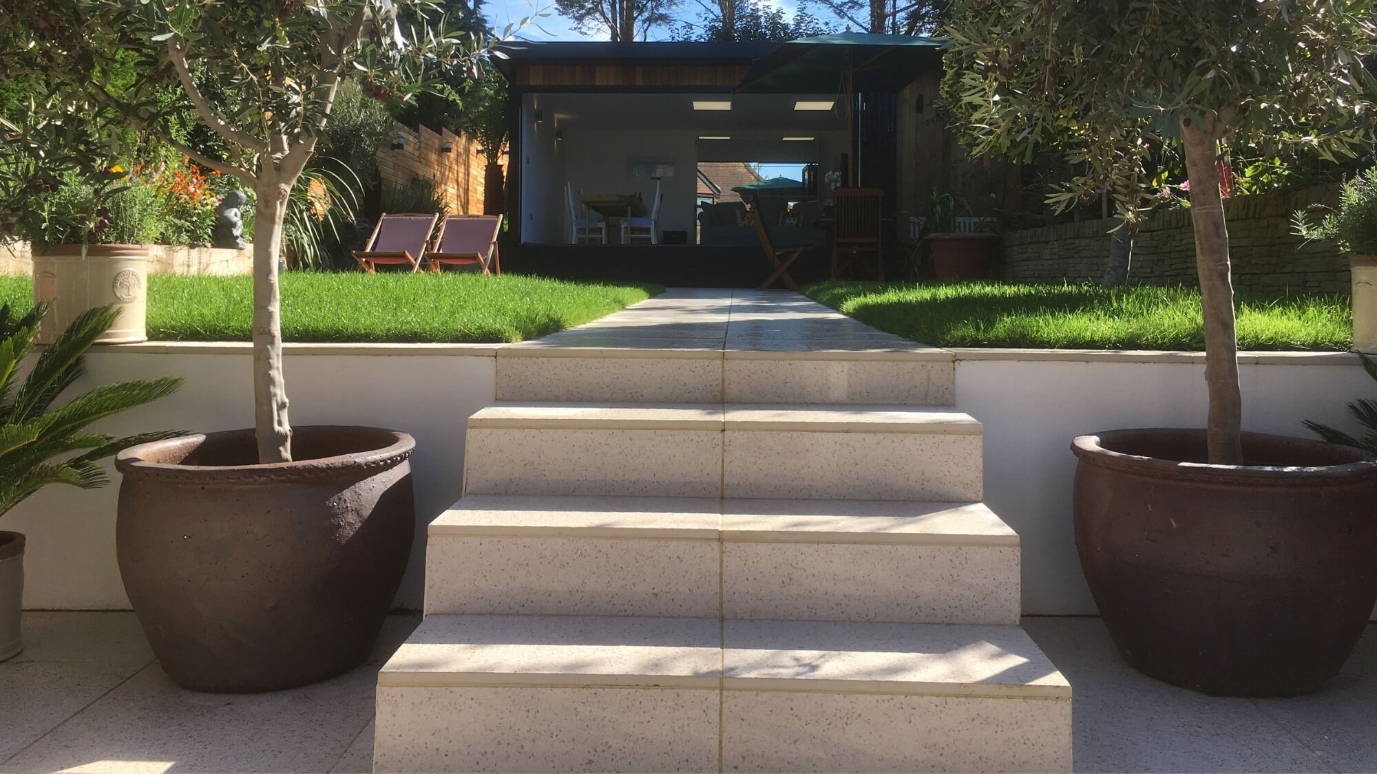 After: new stone garden steps with olive tree planters in a design-led Carshalton Beeches garden