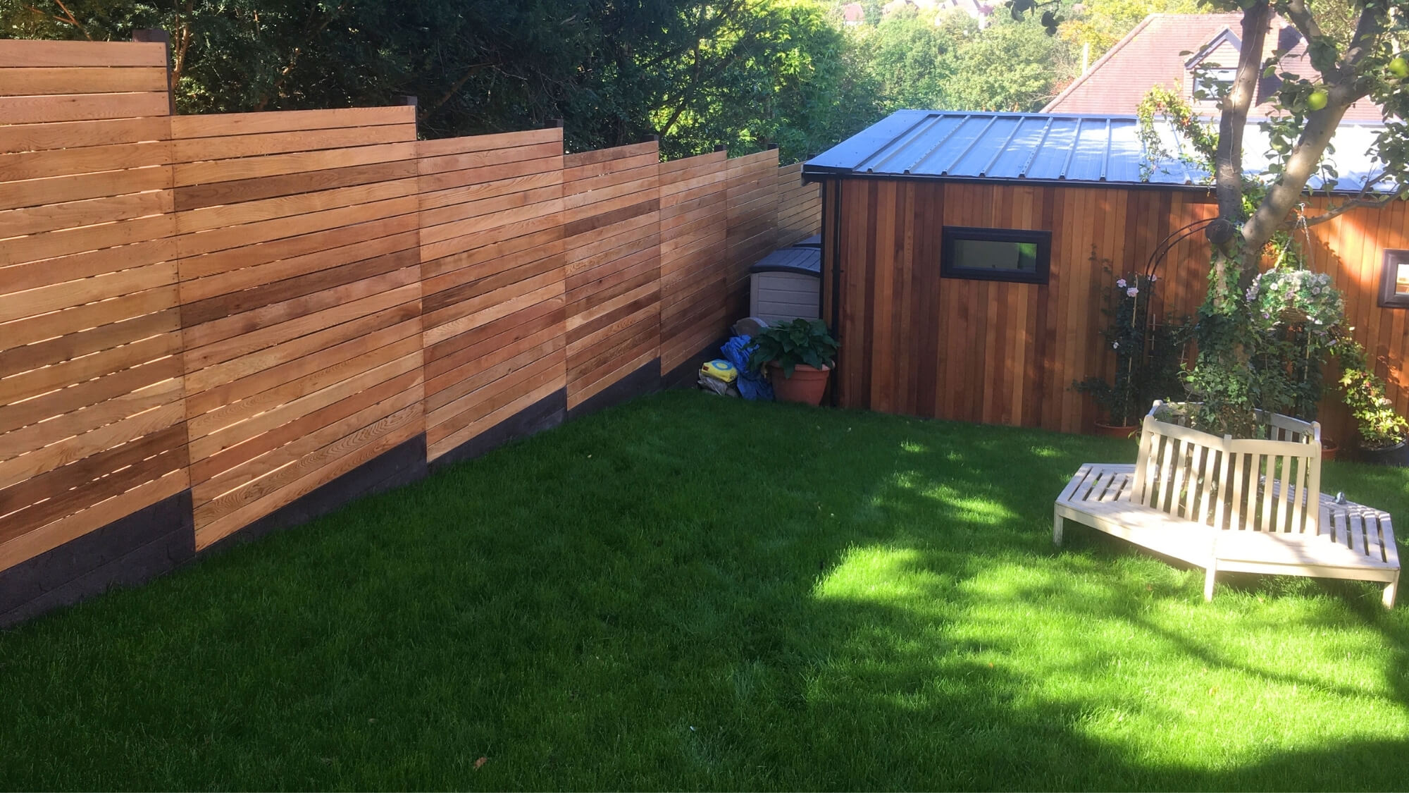 After: contemporary cedar timber fencing and garden studio integrated into a Carshalton Beeches garden