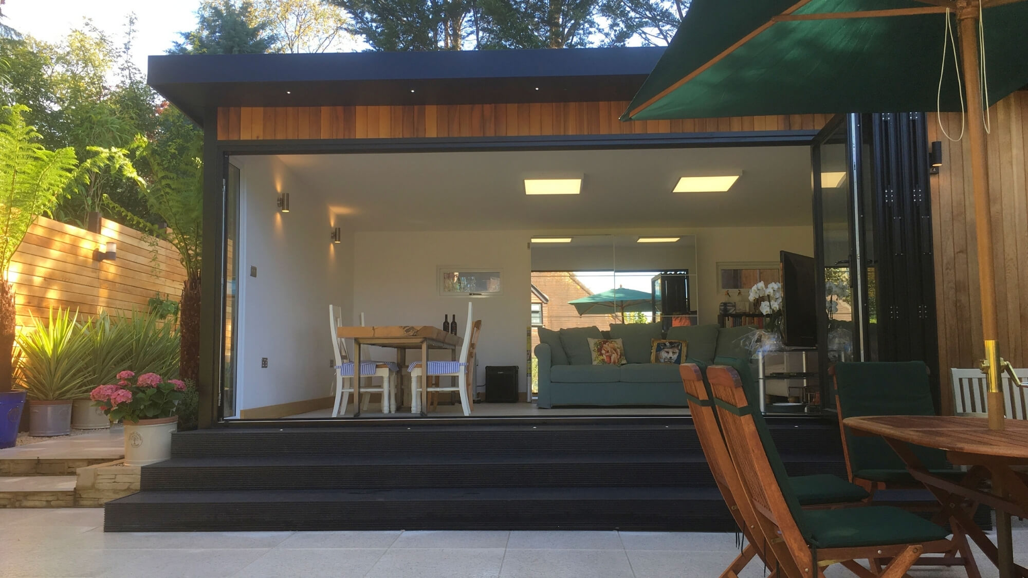 Modern garden room and composite deck completed as part of a full garden redesign in Carshalton Beeches, South London