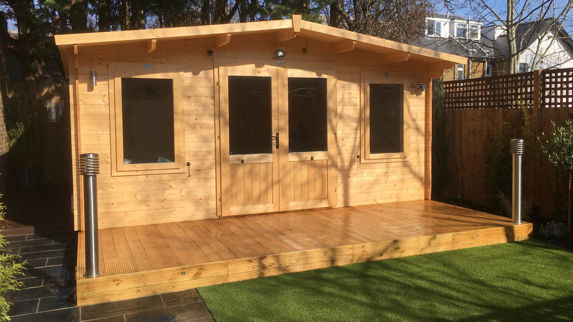 Timber garden studio with decked frontage, bespoke garden room design by EarthCare Gardens in South London