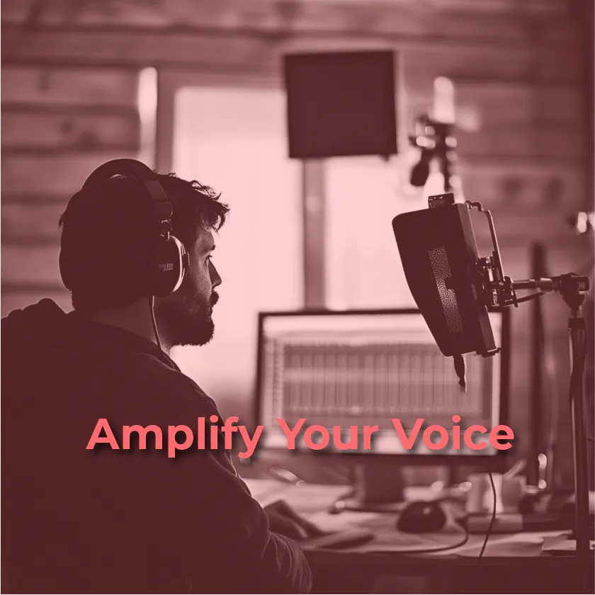 A person with dark hair and a beard is shown from the shoulders up, facing right, wearing headphones and speaking into a microphone in a recording studio. The background is slightly blurred, showing recording equipment and a computer screen displaying audio editing software. The text "Amplify Your Voice" is superimposed in a reddish-pink color in the lower center of the image.
