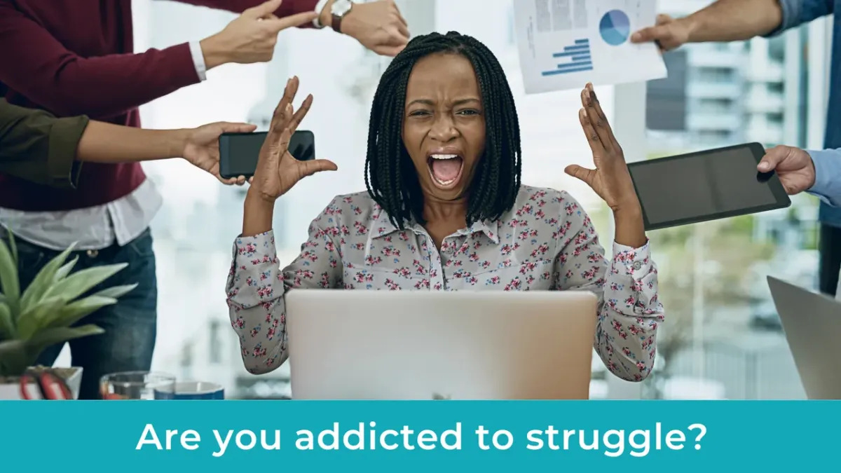 Overwhelmed bookkeeper working late at desk surrounded by paperwork and laptop
