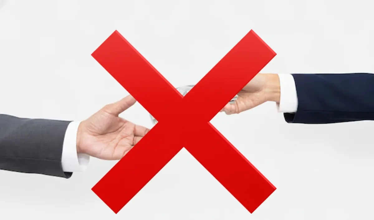 Two hands exchanging money with a large red X over them, symbolizing no payment required.