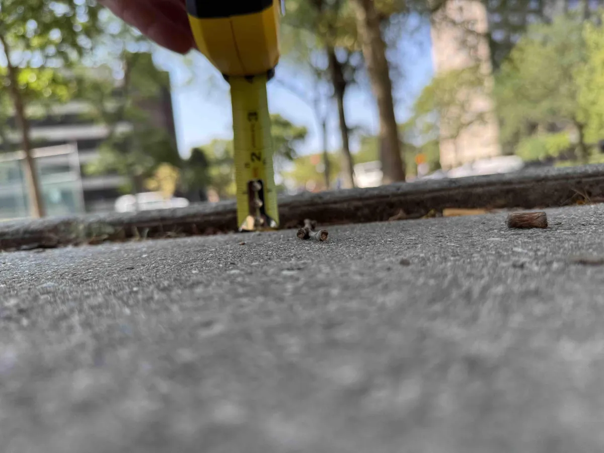 measuring the uneven pavement with a ruler