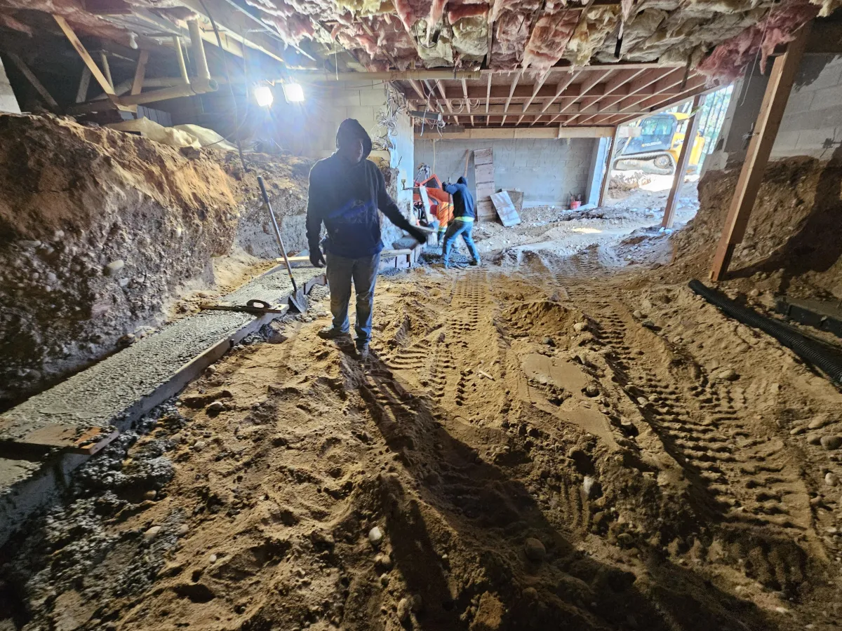 Basement addition in Dane County WI. Guys pouring the footer for the foundation wall.