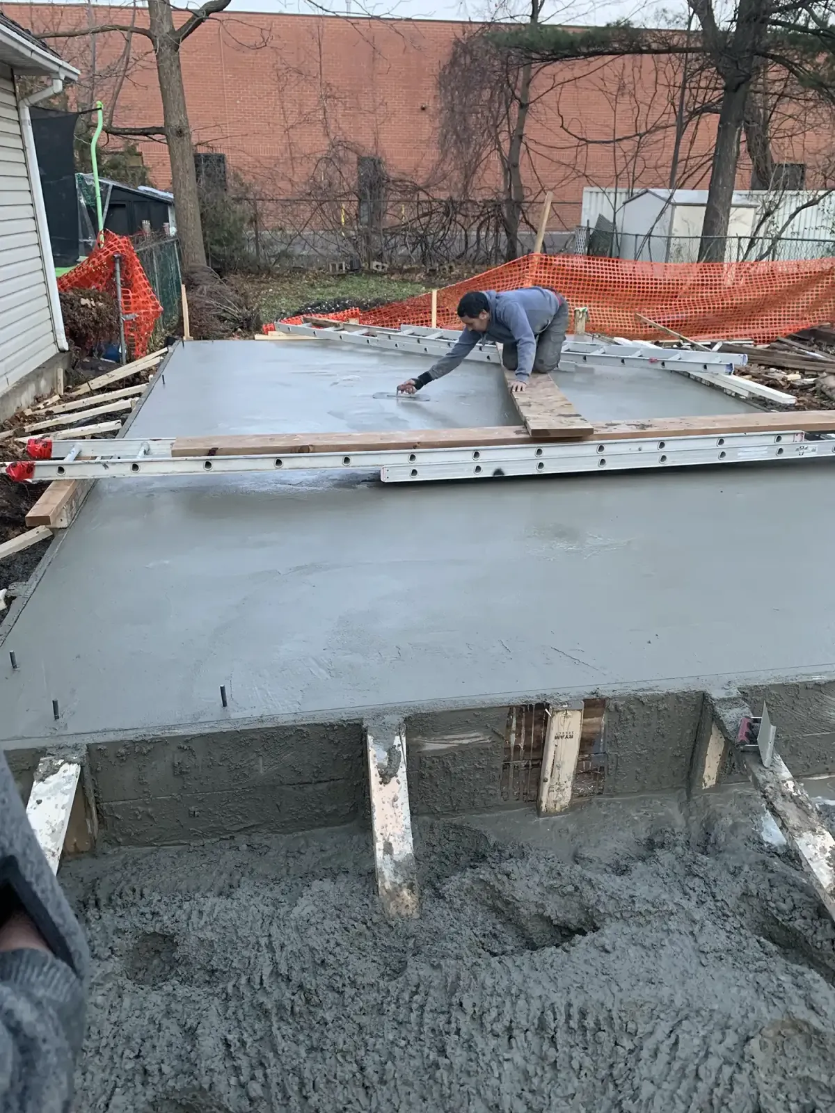 In process of pouring concrete for a backyard project in Toronto By Build 4 Outdoors