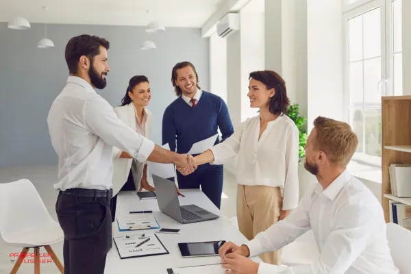 Confident professional with visual cues of branding elements like spotlight, profile icons, and handshake.