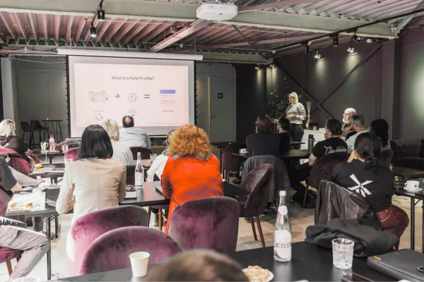 Professional confidently presenting and sharing their expertise, symbolizing the power of strategic visibility in career growth.