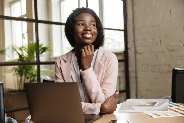 Professional reflecting on their September progress in front of a laptop, capturing self-awareness and career growth insights.