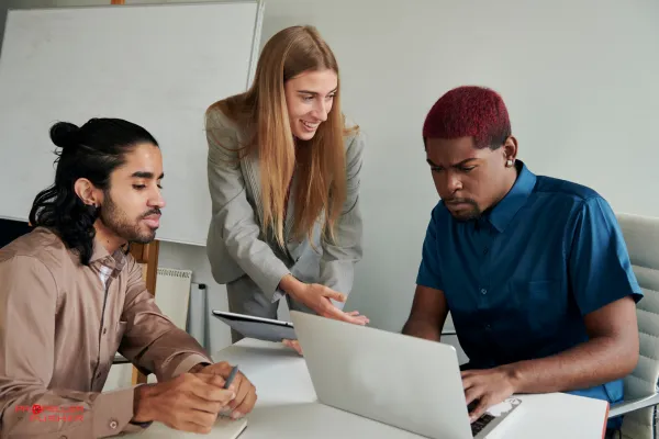 Confident woman leading a team discussion in an office meeting room.